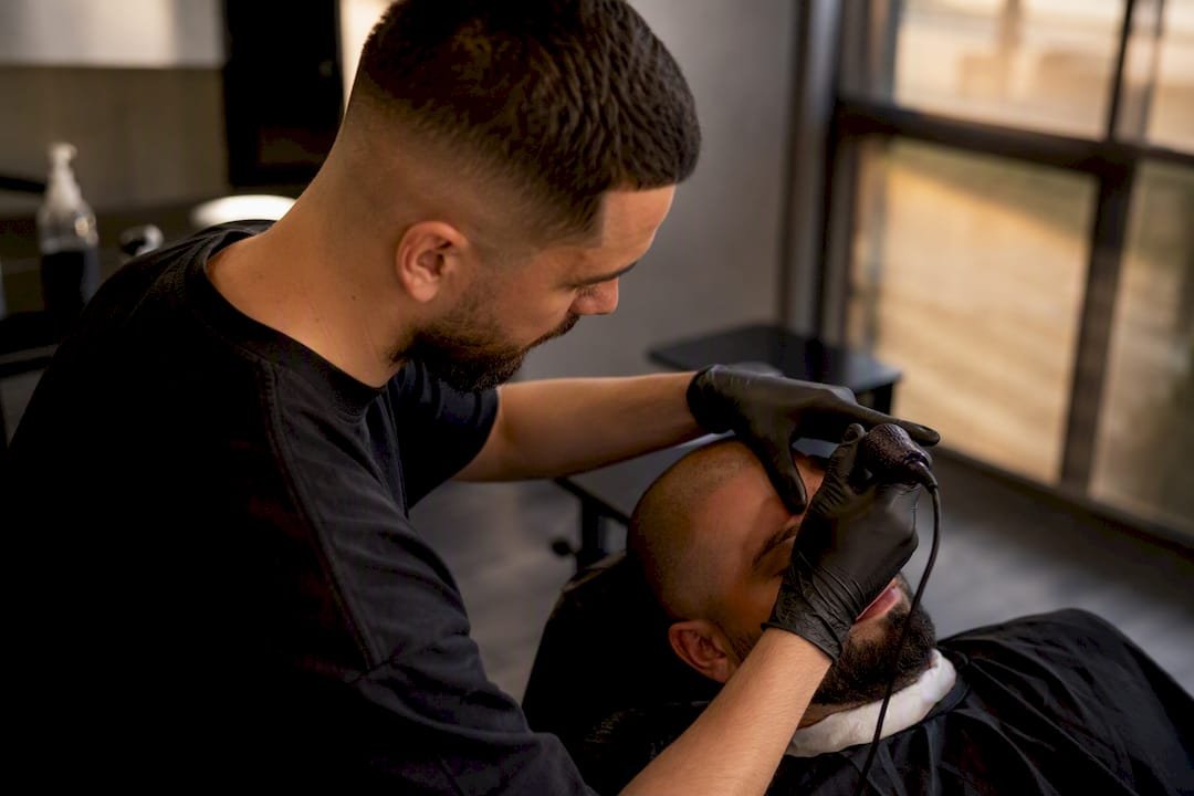 Technician applying scalp micropigmentation