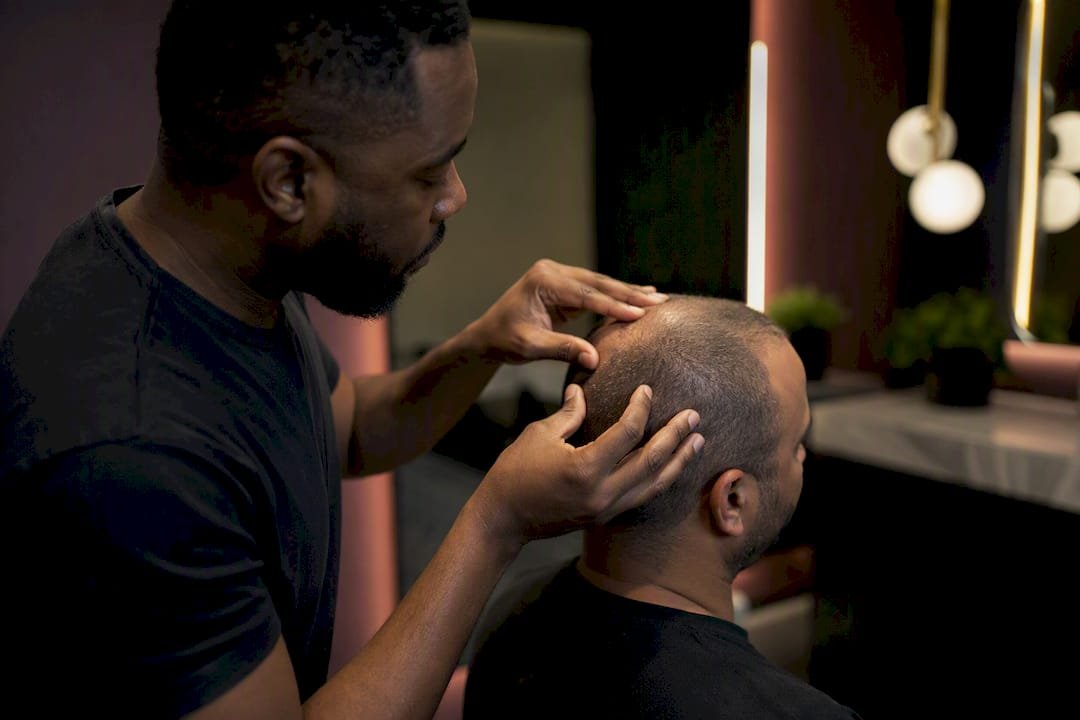 Technician examining scalp in clinic