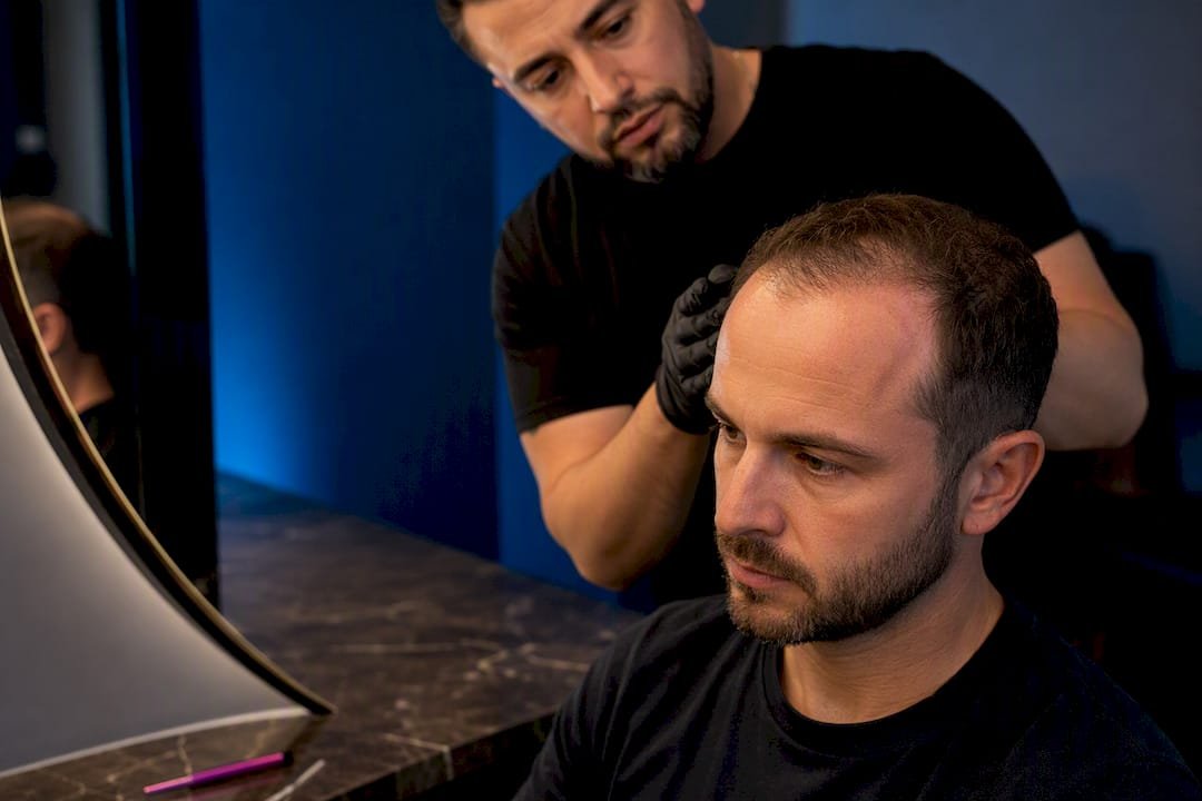 SMP practitioner assessing a conservative hairline