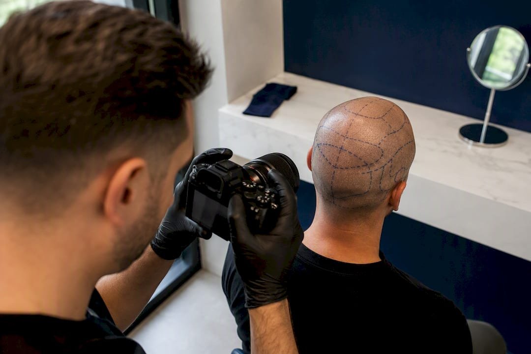 Practitioner documenting mapped scalp before correction