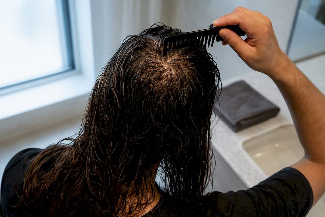 Wet long hair revealing scalp at crown